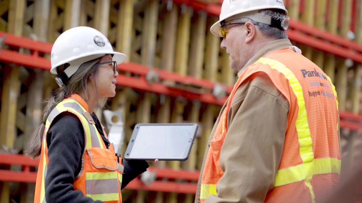 Construction workers looking at iPad